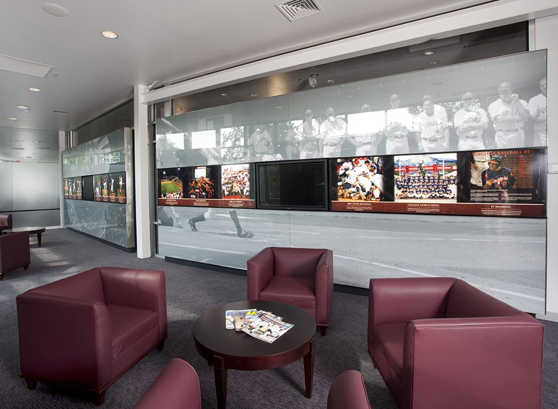 At a more interactive level, the mural walls hold a continuous band of digital and graphic media depicting the most recent timeline of program highlights and relevant data about the program’s history for recruits and players to explore.